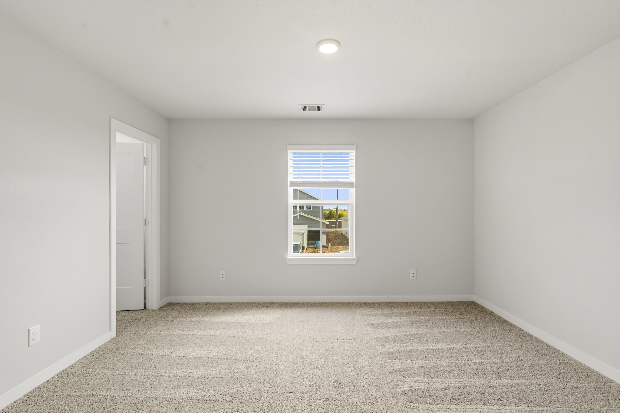 A room with a window and a door.