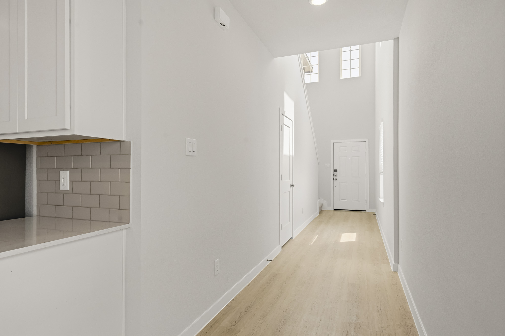A hallway with white walls.