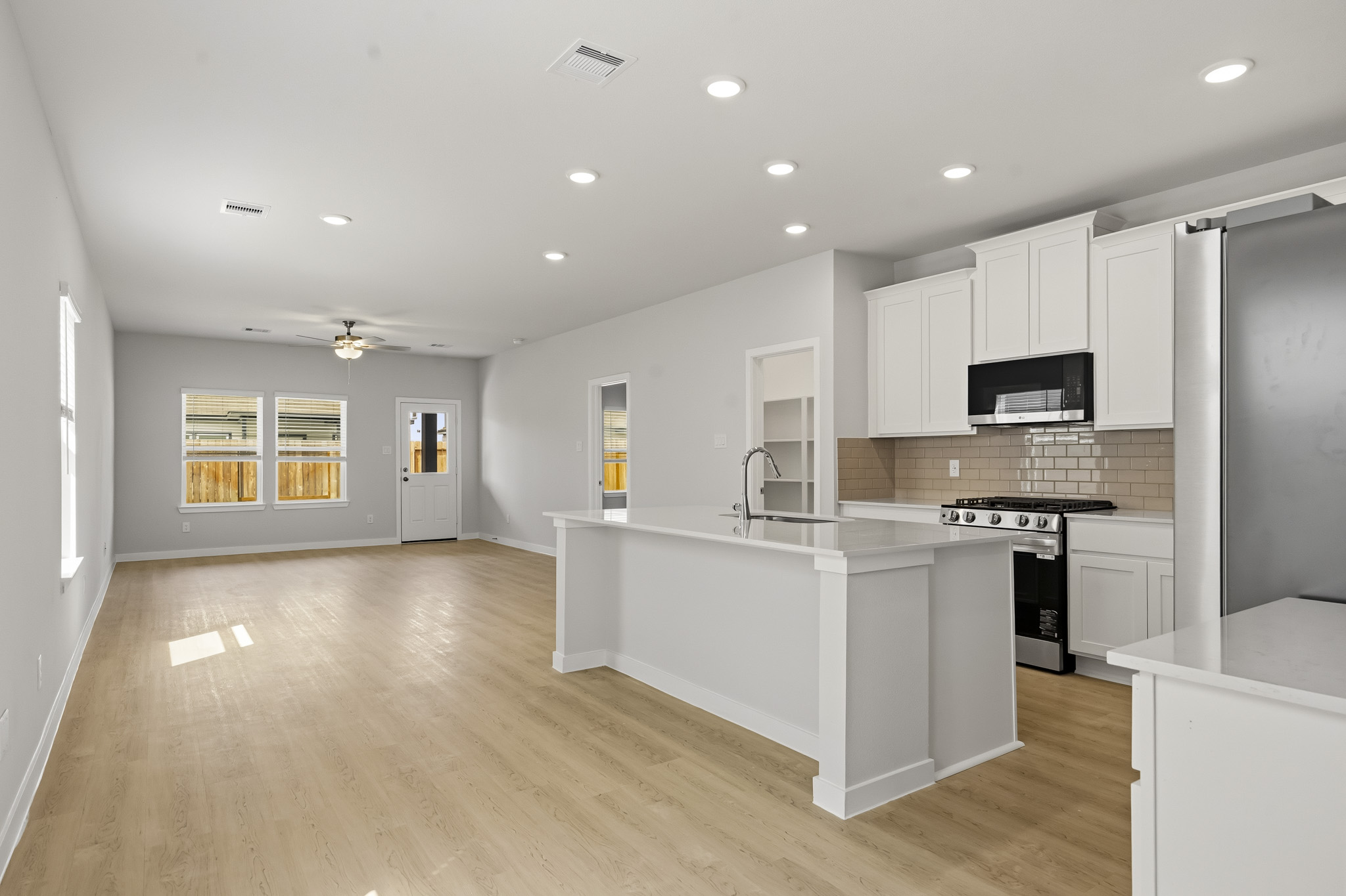 A kitchen with white cabinets.
