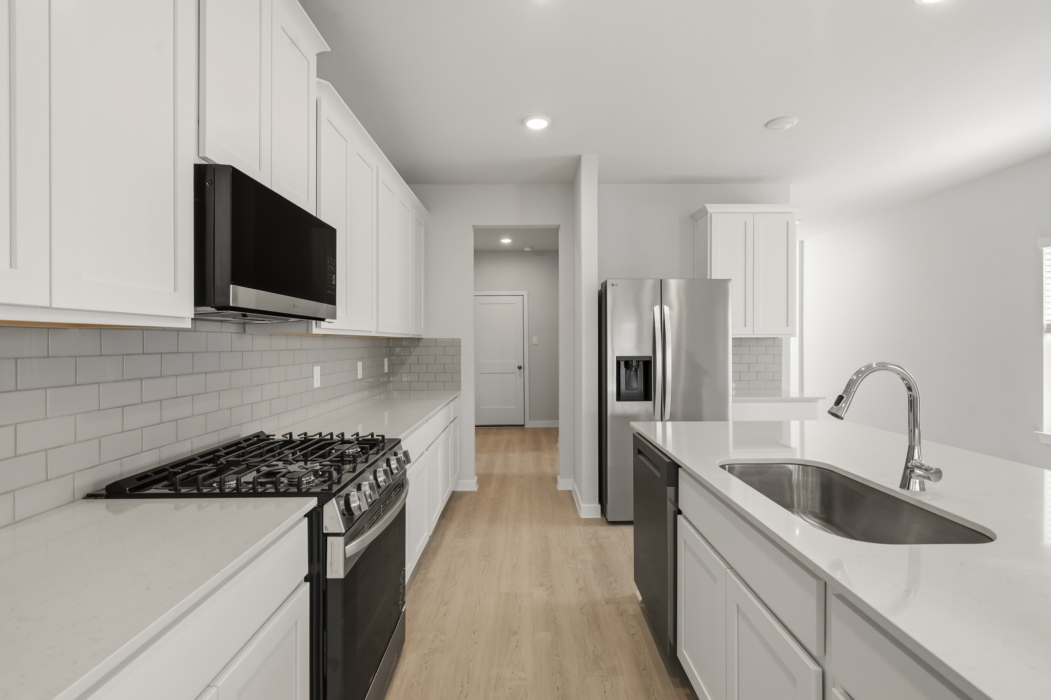 A kitchen with white cabinets.