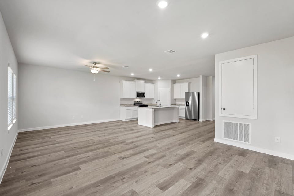 A kitchen with white cabinets.