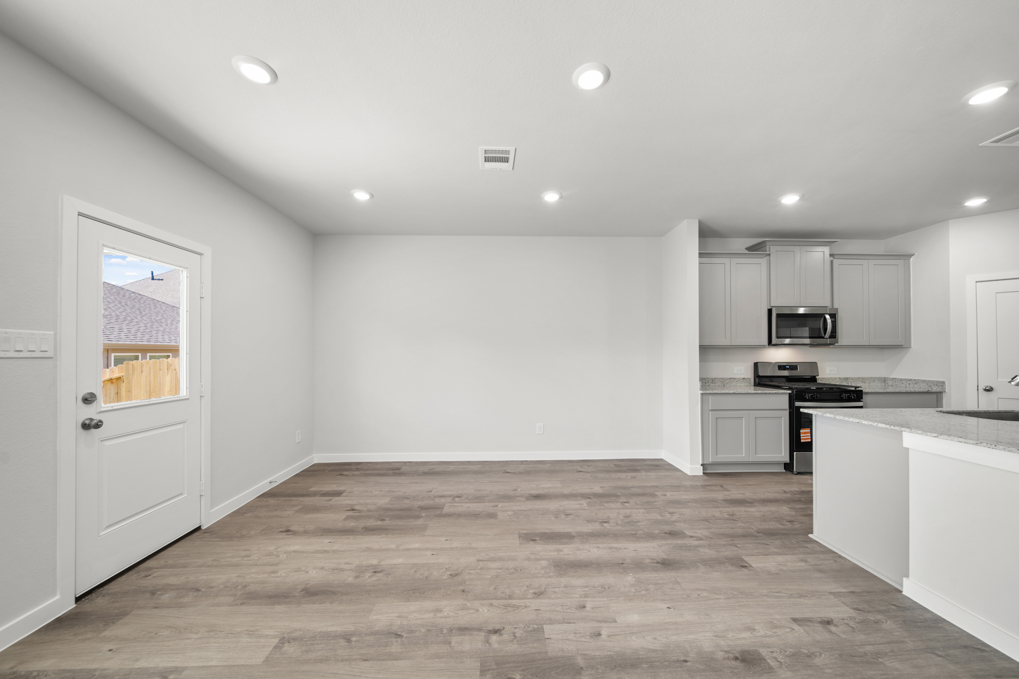 A kitchen with white cabinets.