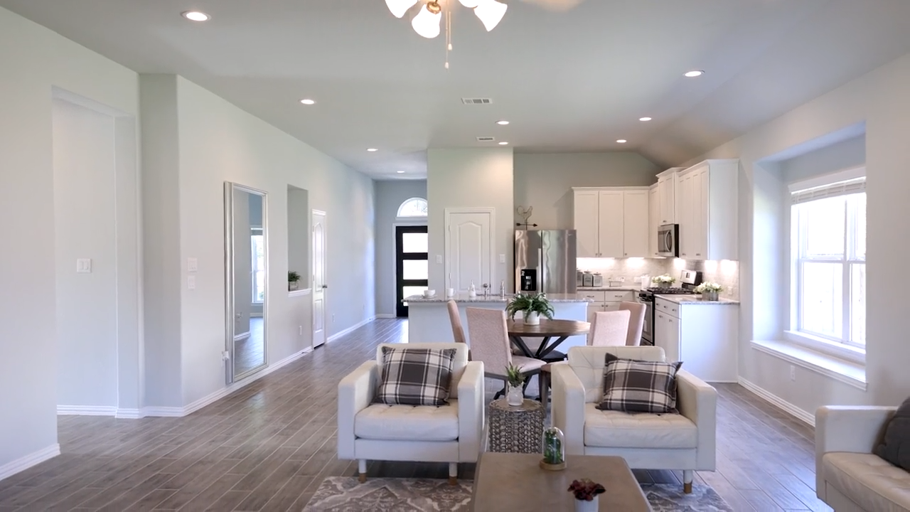 A large living room with white furniture.