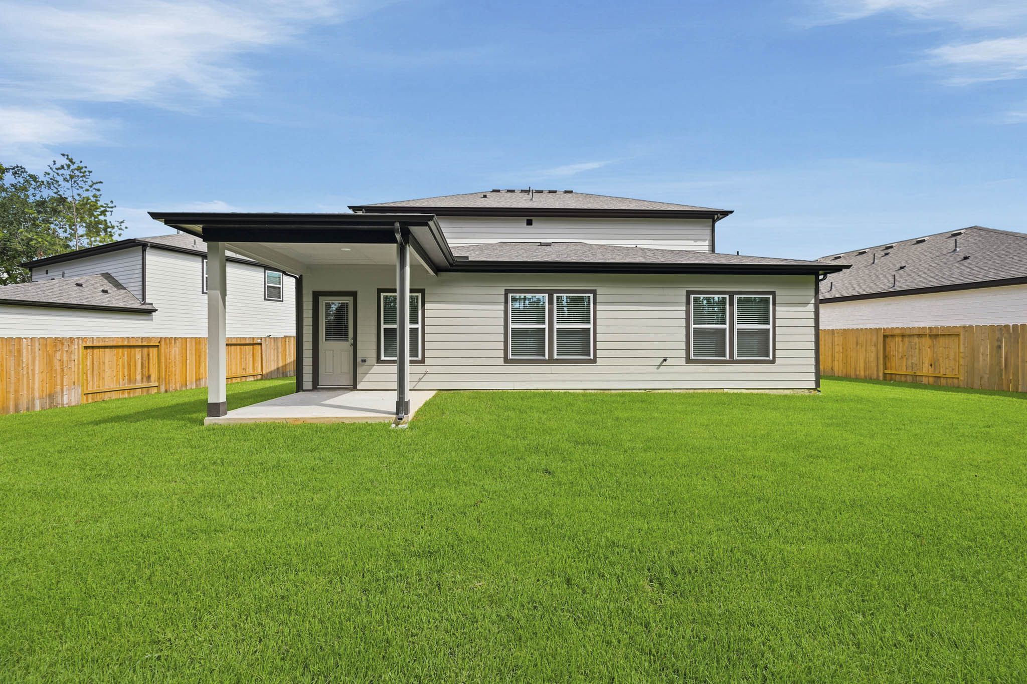 A house with a fence and grass.