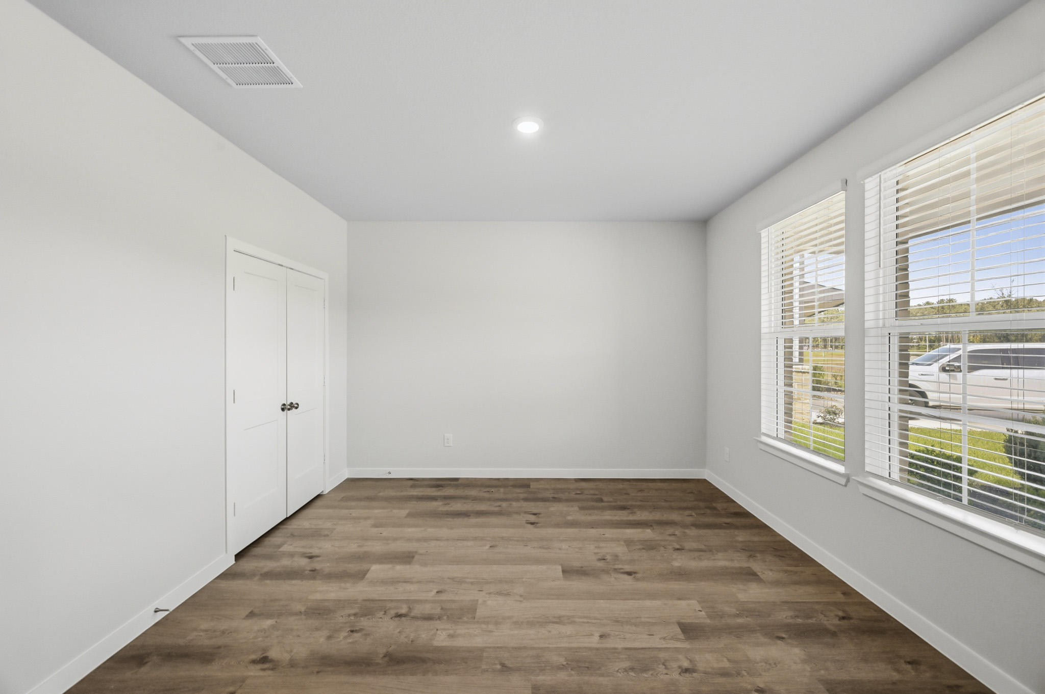 A room with white walls and windows.