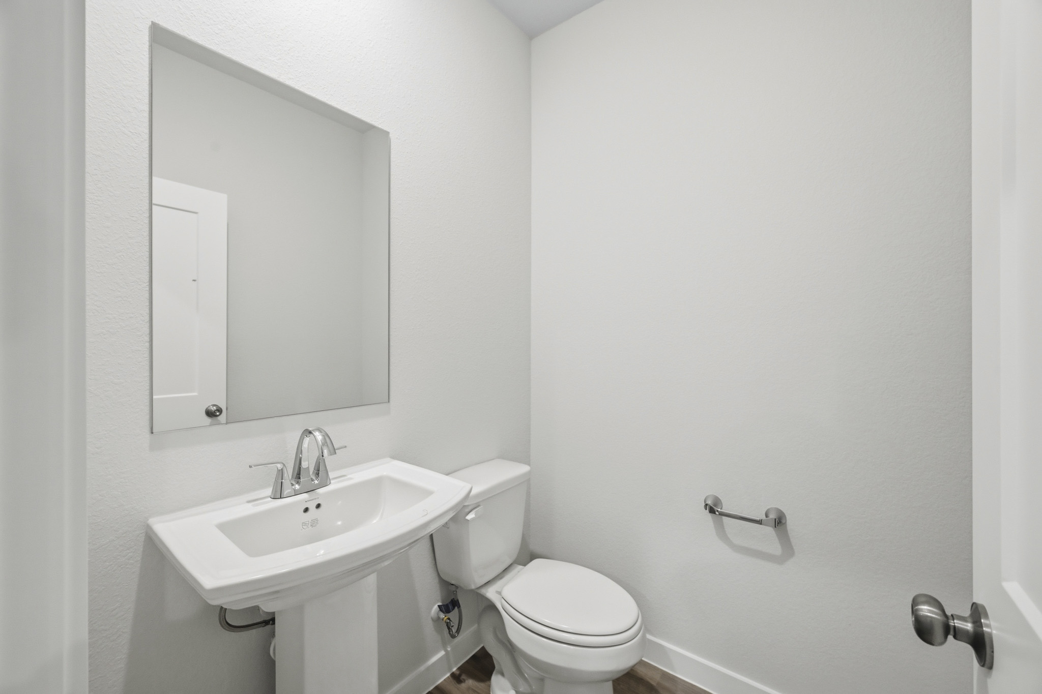 A bathroom with a toilet and sink.