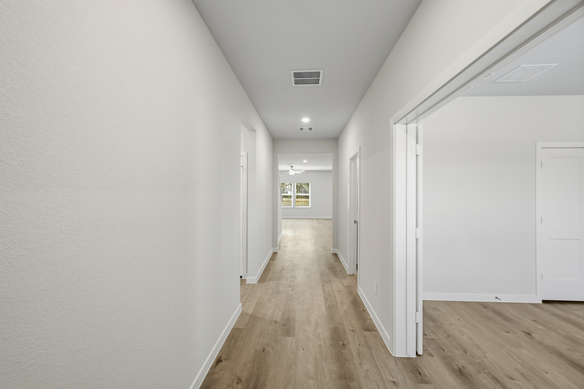 A hallway with white doors.