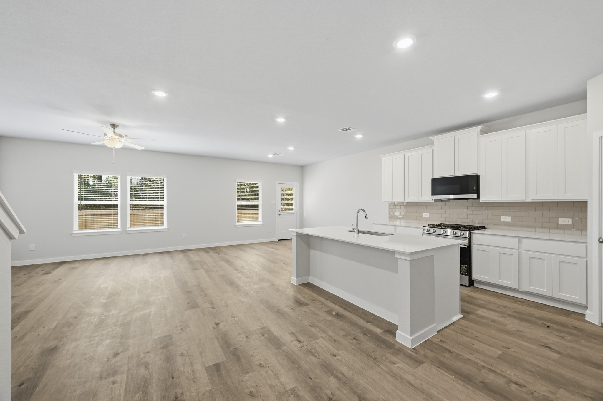 A kitchen with white cabinets.