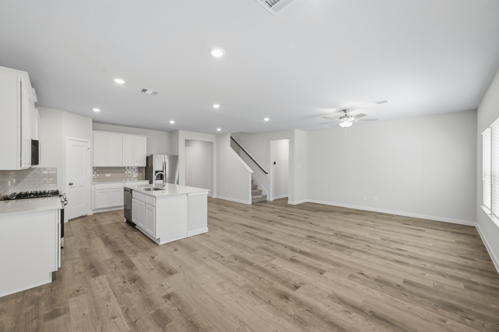 A large kitchen with white cabinets.