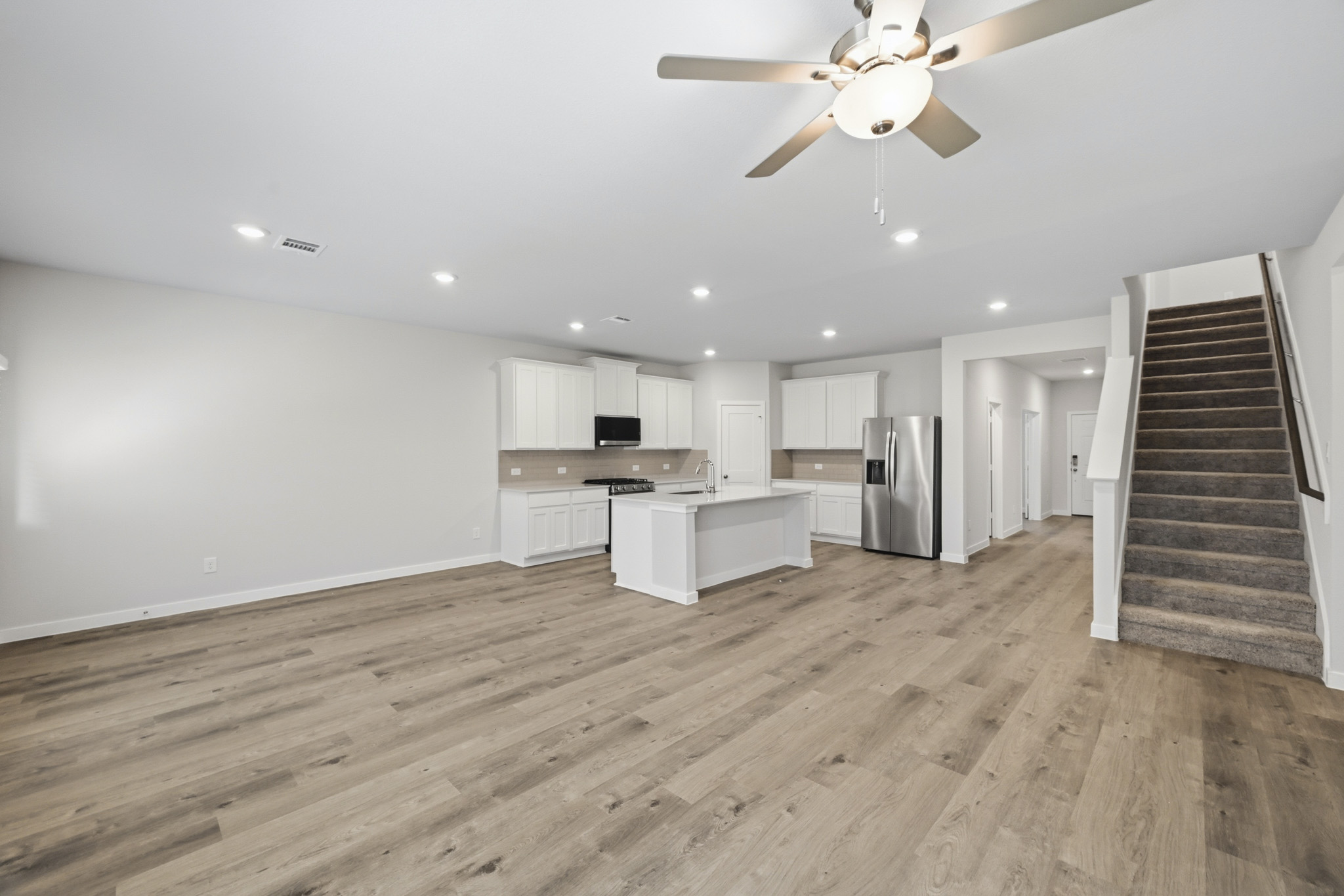 A large kitchen with a wood floor.