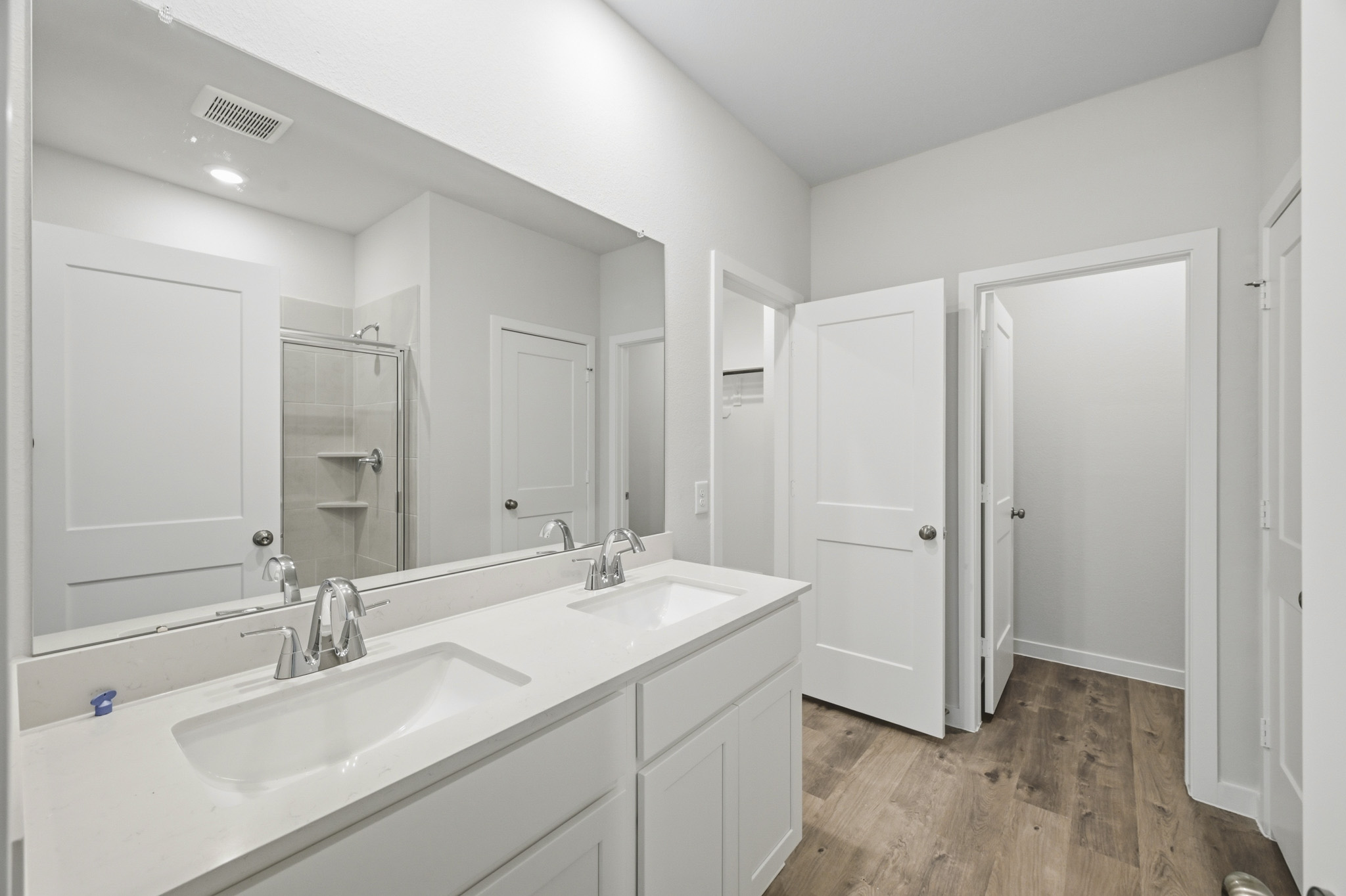 A bathroom with white cabinets.