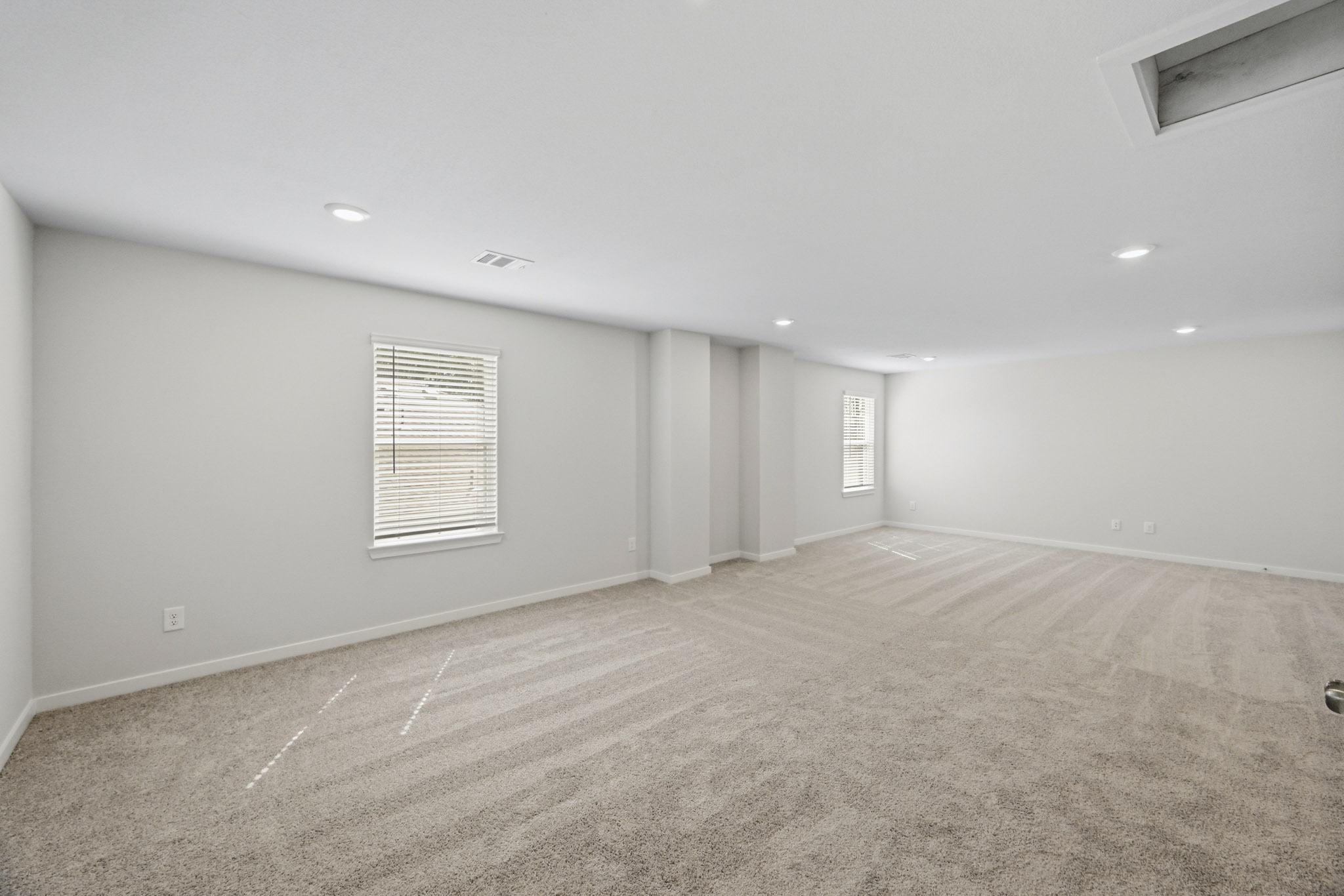 A room with a carpet and a door.
