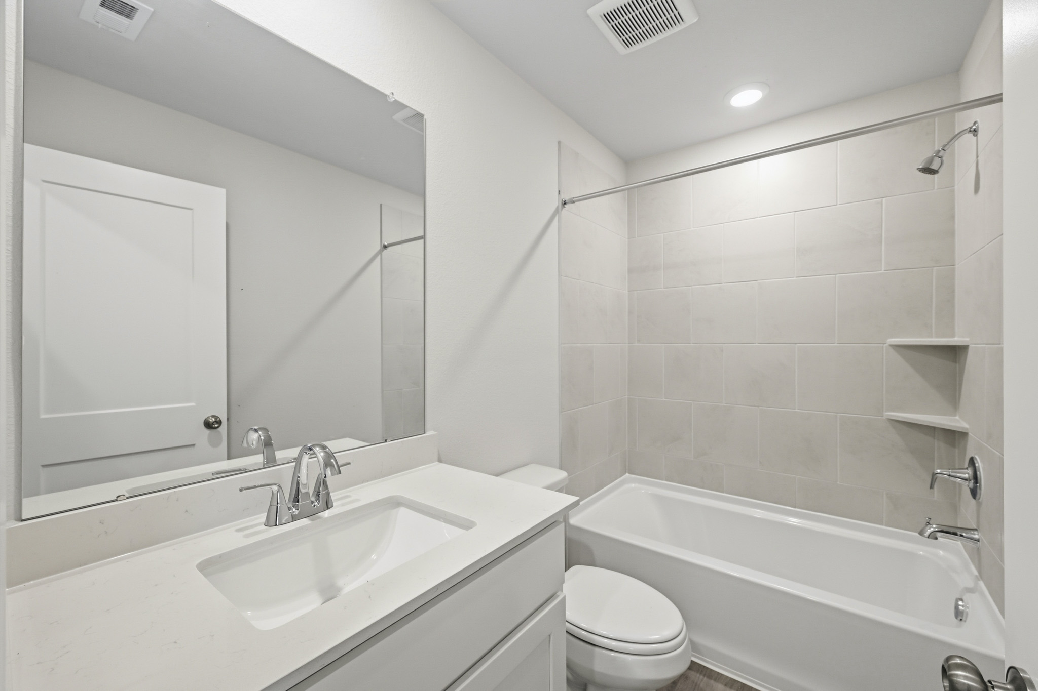 A bathroom with a sink toilet and bathtub.