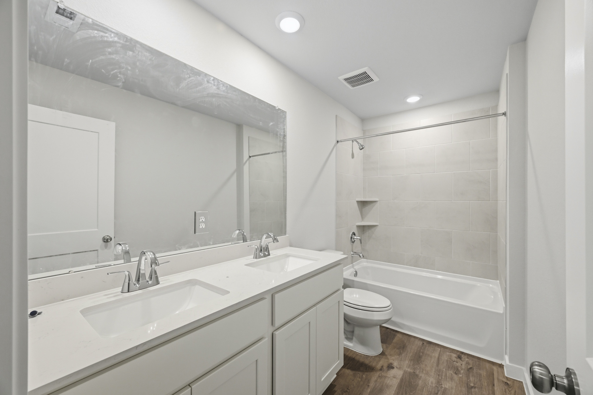 A bathroom with a tub sink and toilet.