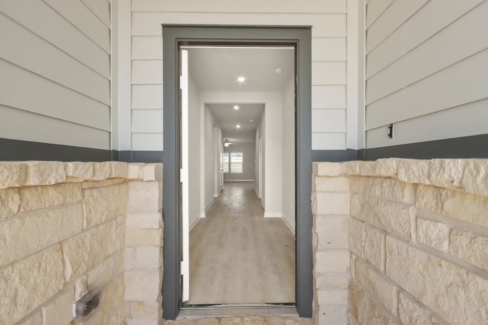 A hallway with a stone wall.