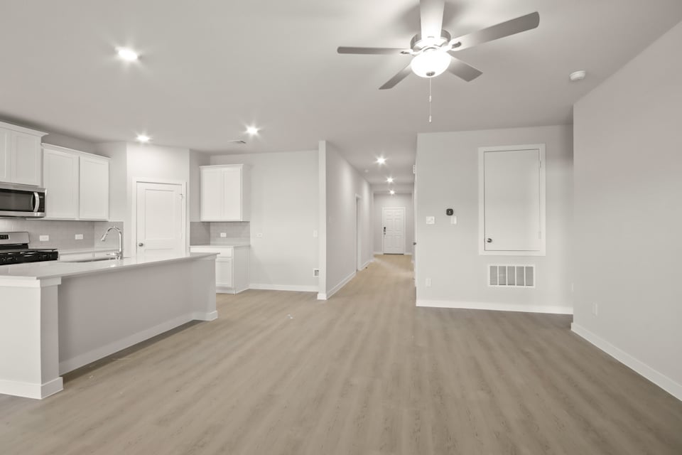 A kitchen with white cabinets.