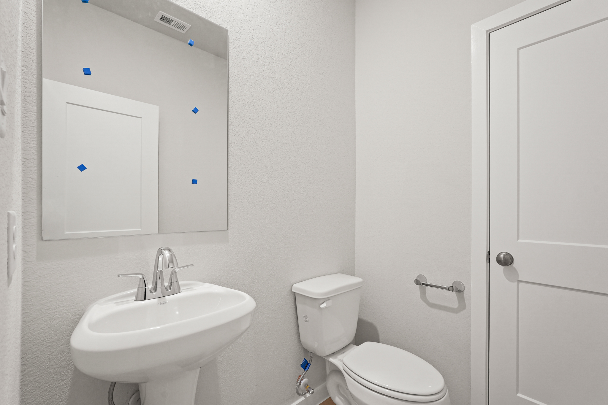 A bathroom with a toilet and sink.