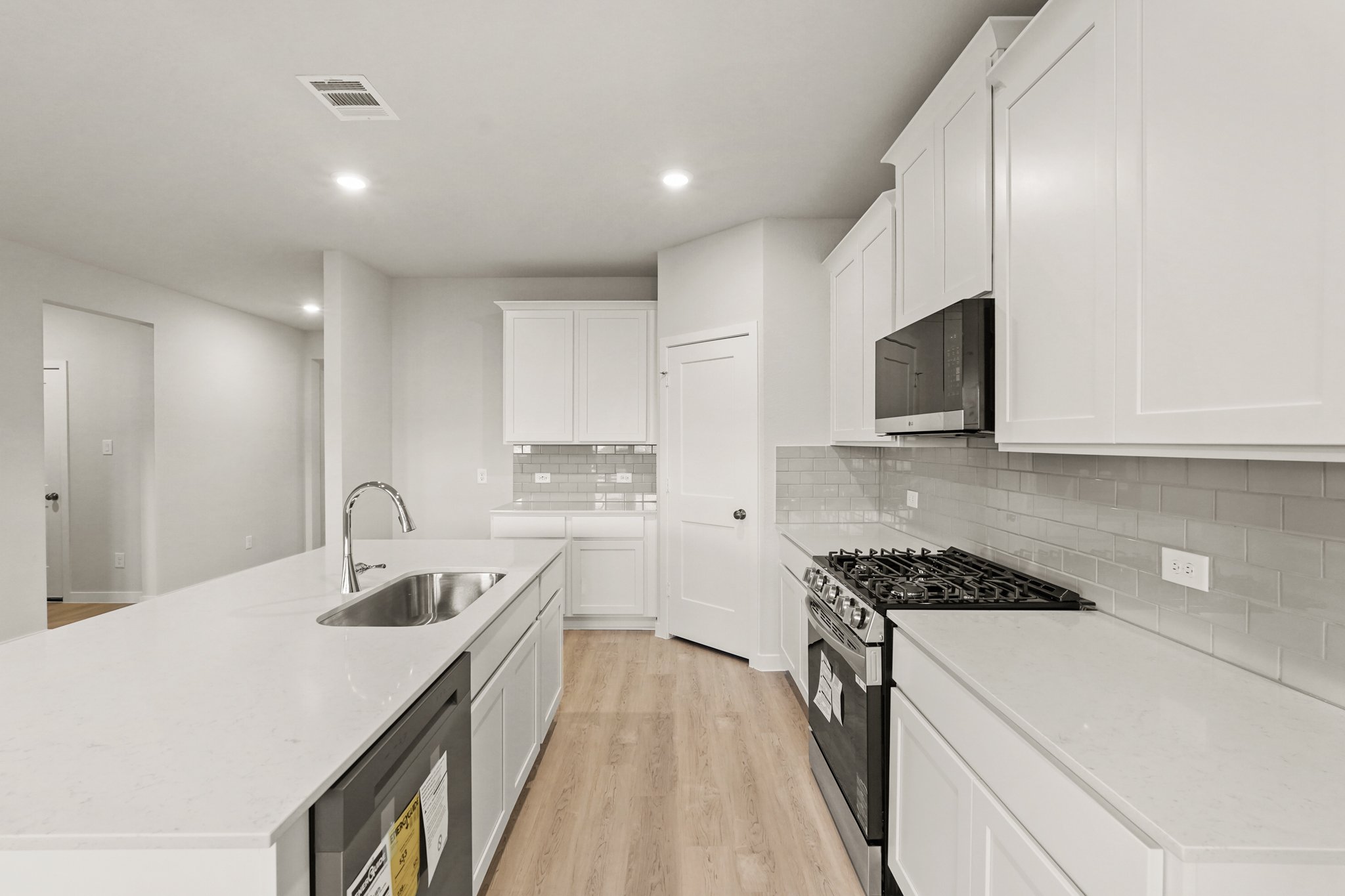 A kitchen with white cabinets.