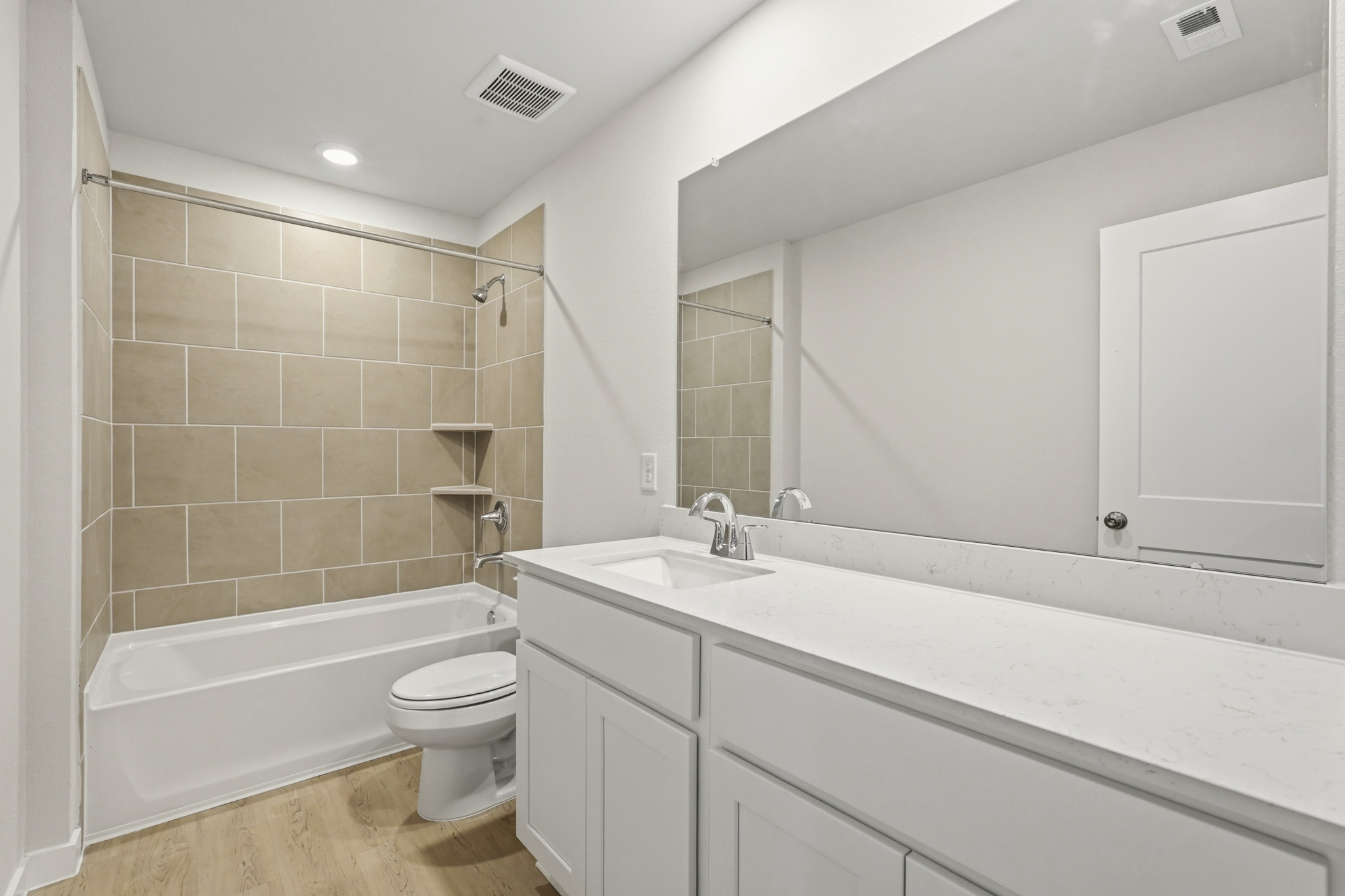A bathroom with a tub sink and toilet.