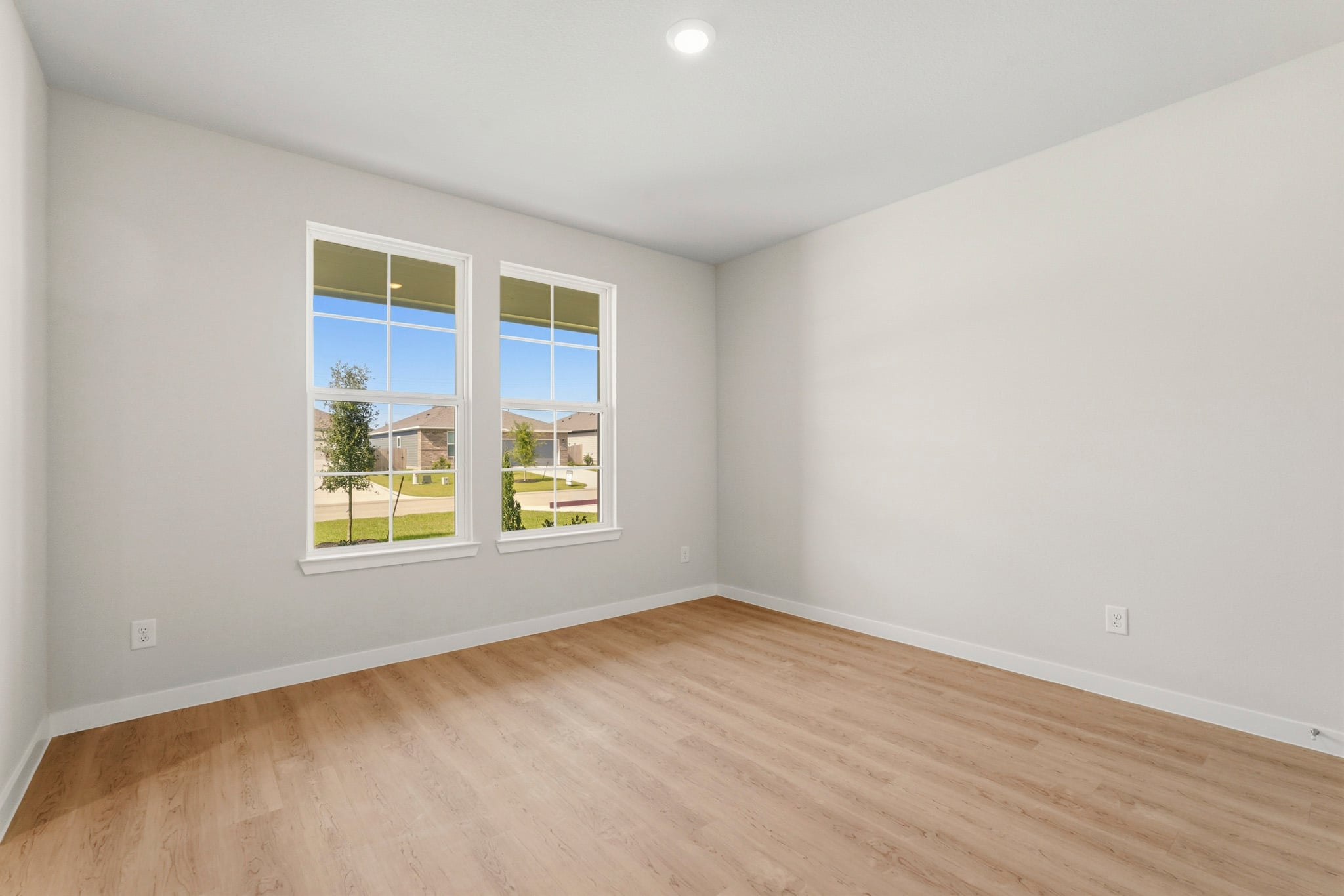 A room with a wood floor and a window with a wood floor.
