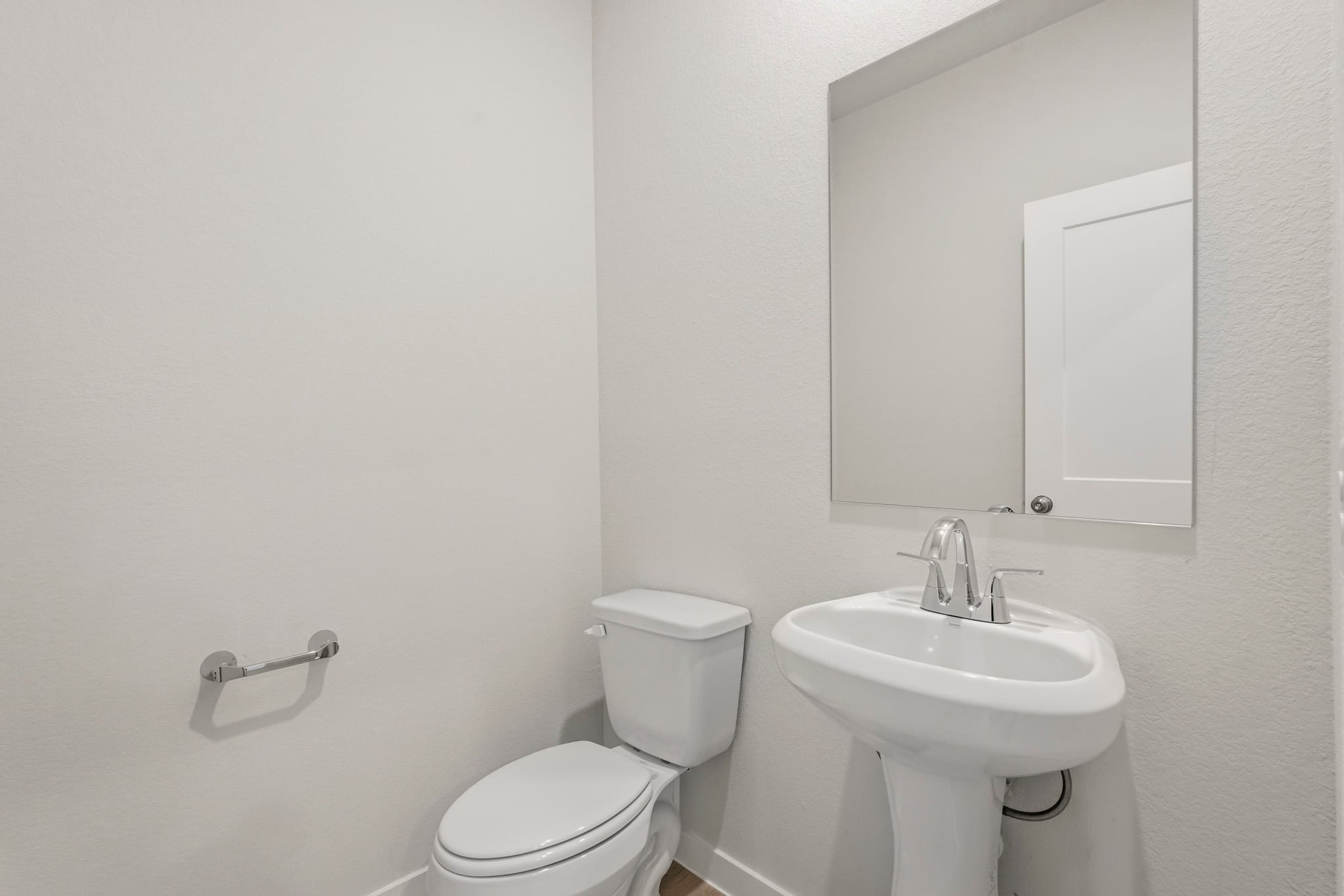 A bathroom with a toilet and sink.
