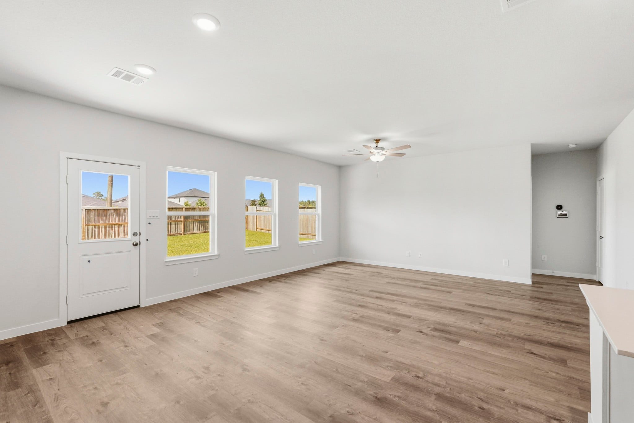 A room with a wood floor and white walls.