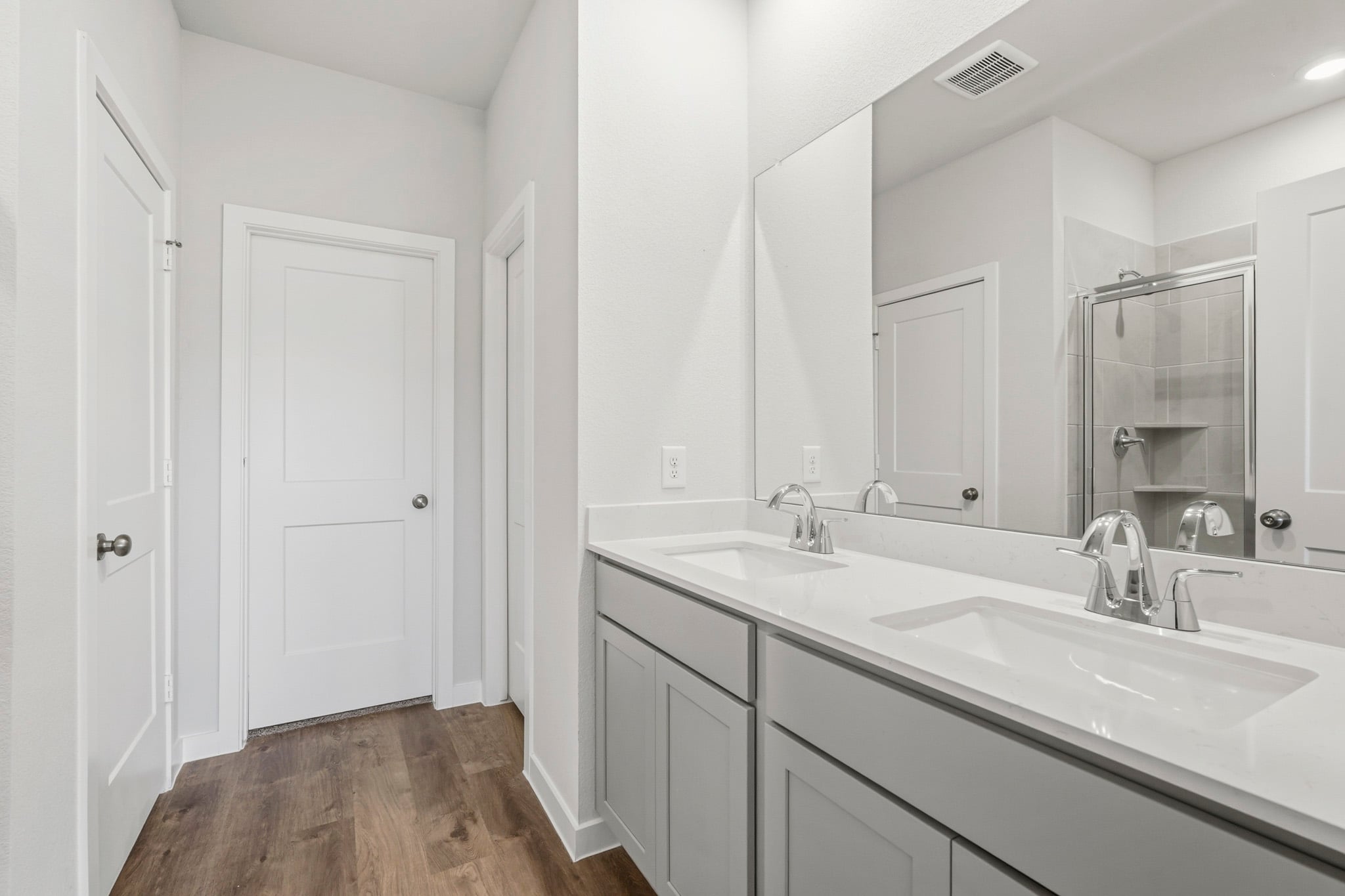 A bathroom with a large mirror.