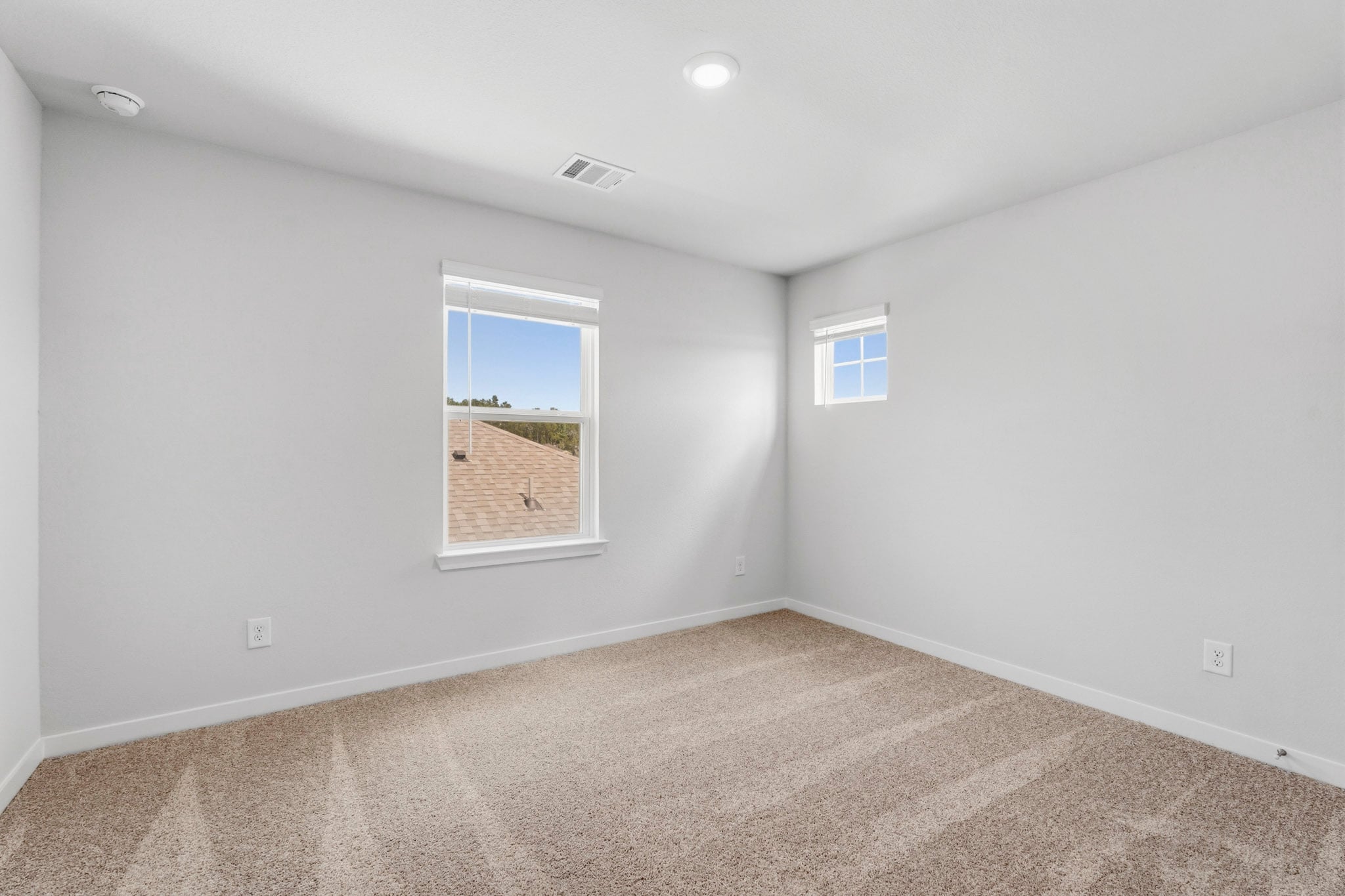 A room with a window and a carpet.