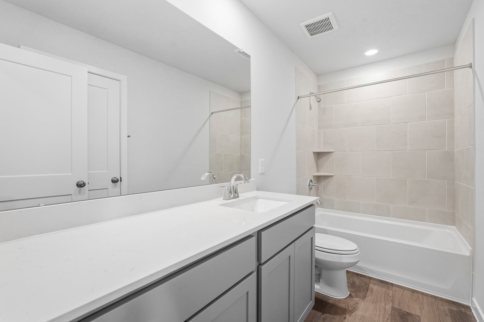A bathroom with a tub sink and toilet.
