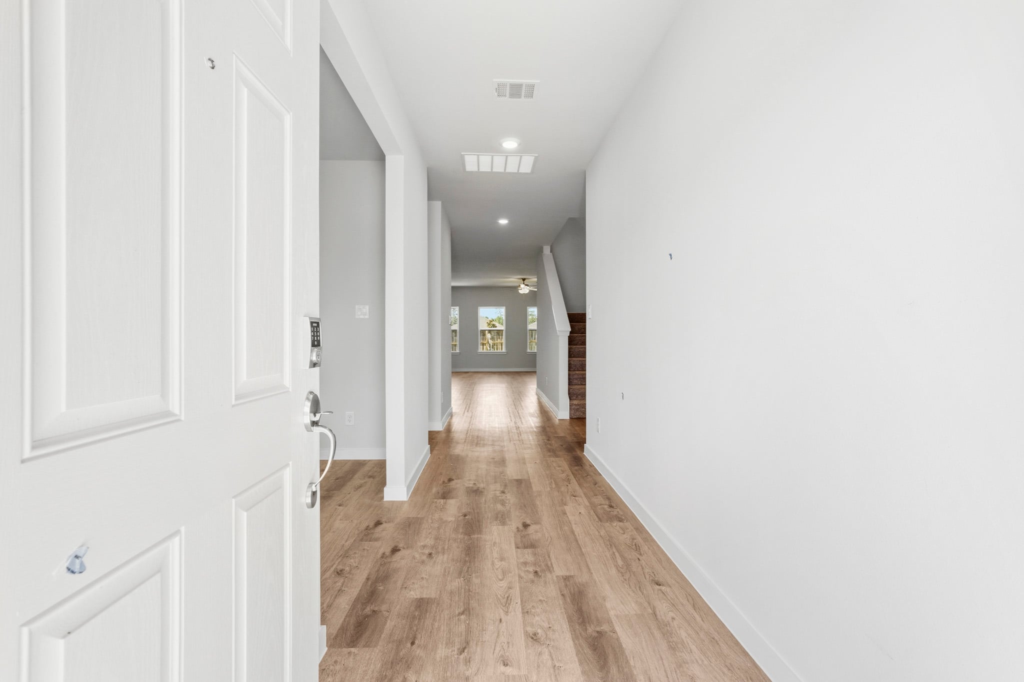 A hallway with white doors.