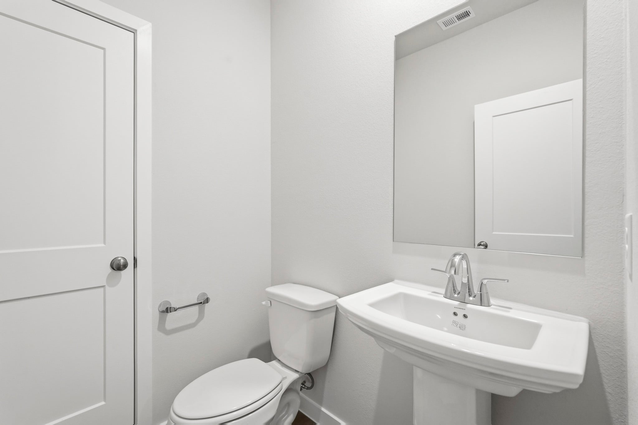 A bathroom with a toilet and sink.