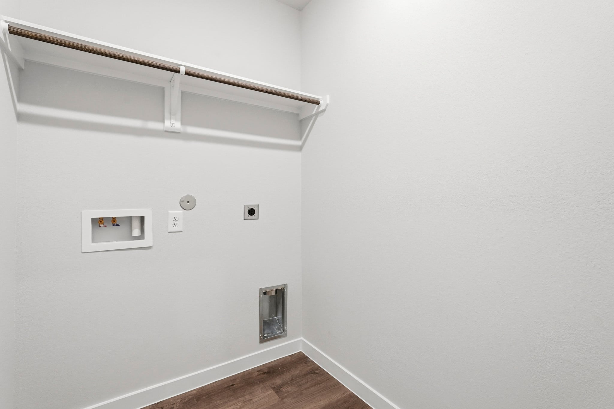 A white wall with a light fixture.