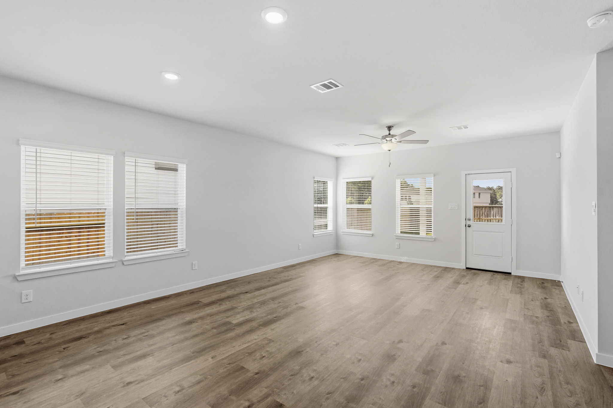 A room with a wood floor and white walls.