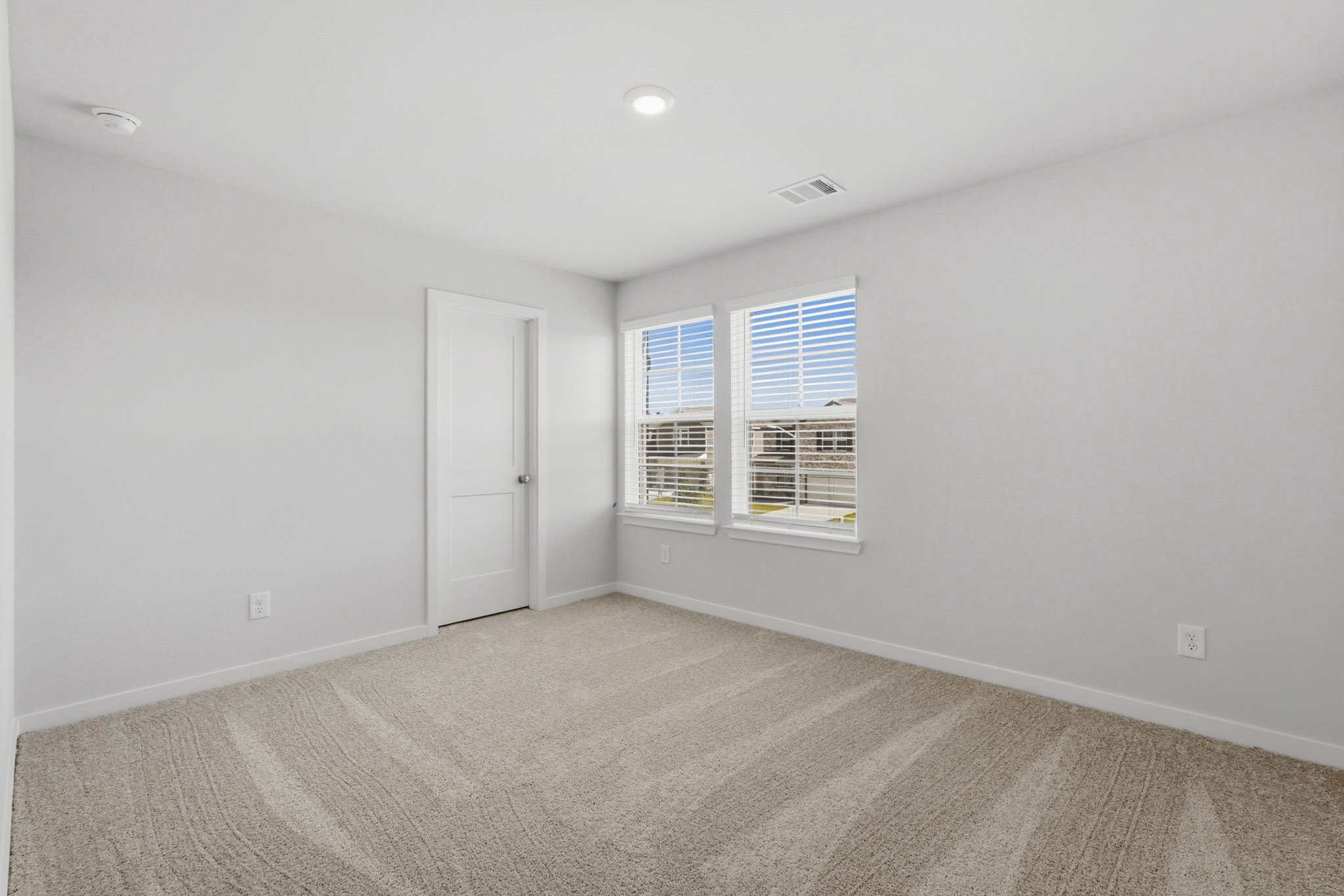 A room with a door and windows.