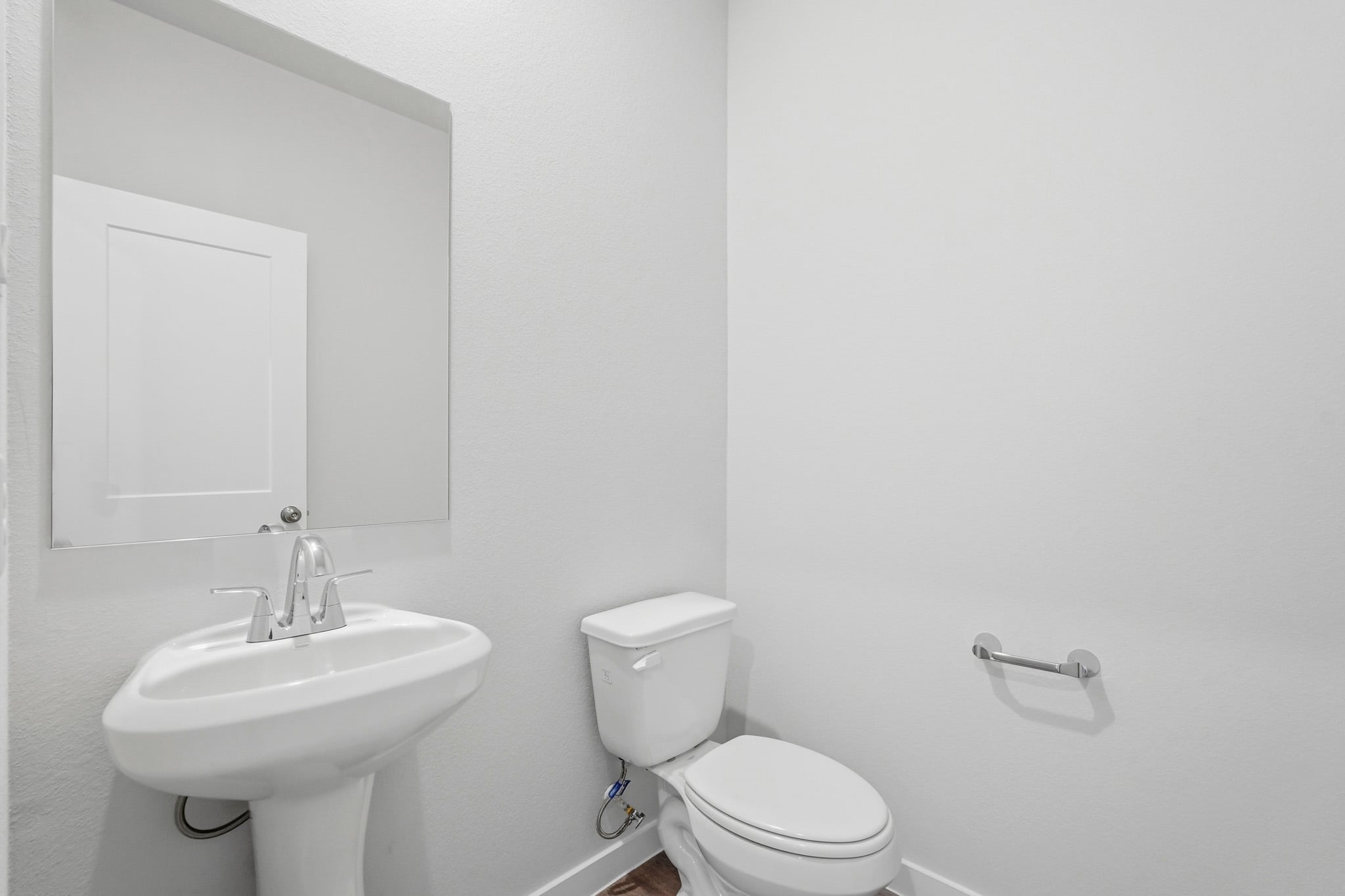 A bathroom with a toilet and sink.