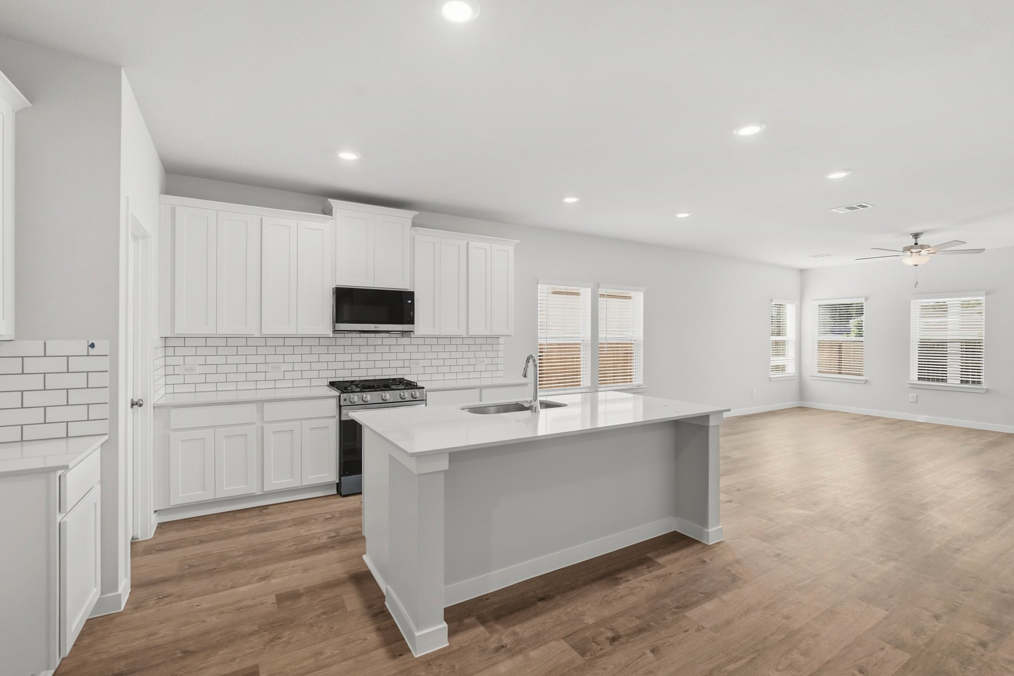 A kitchen with white cabinets.