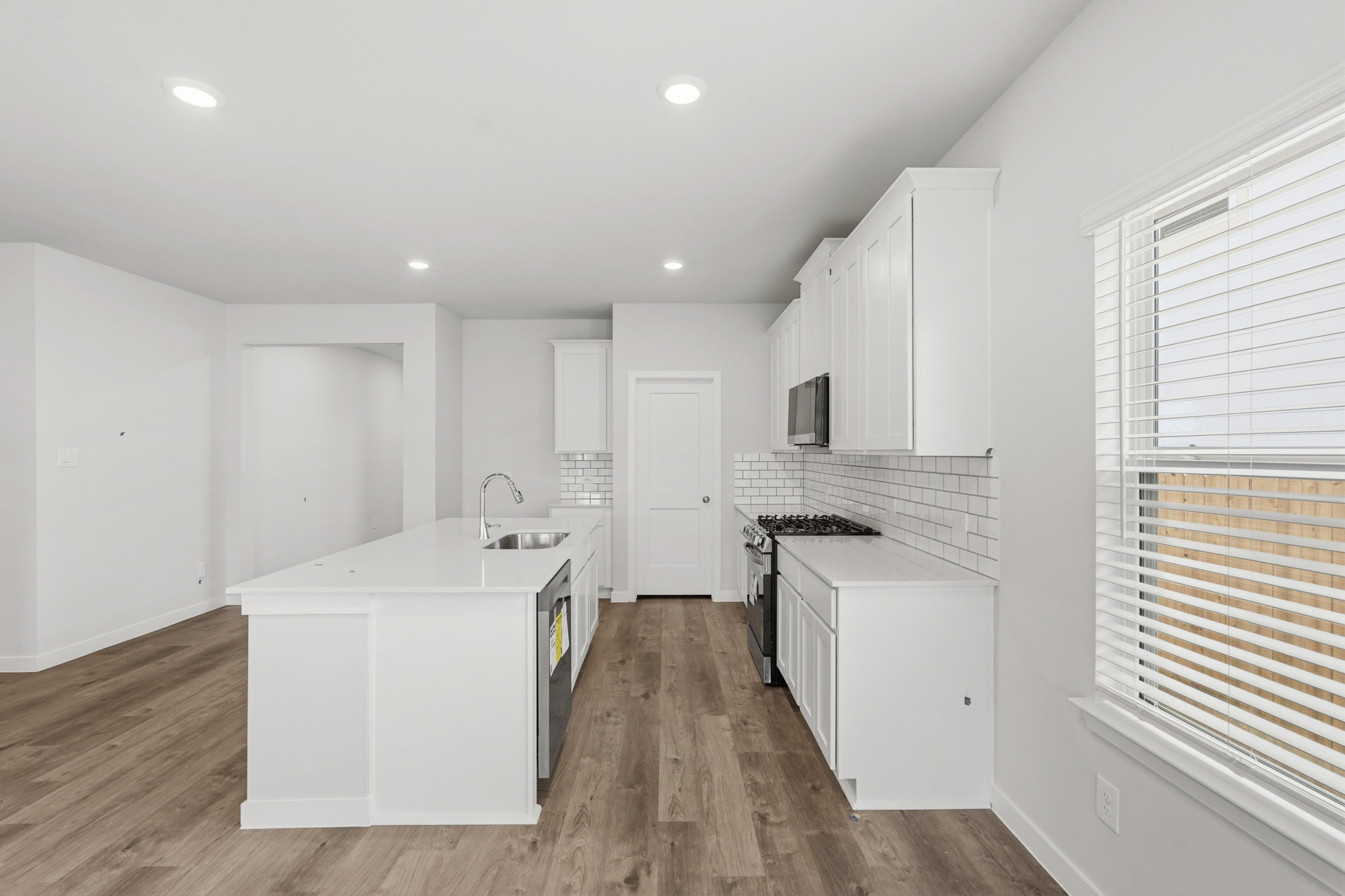 A kitchen with white cabinets.