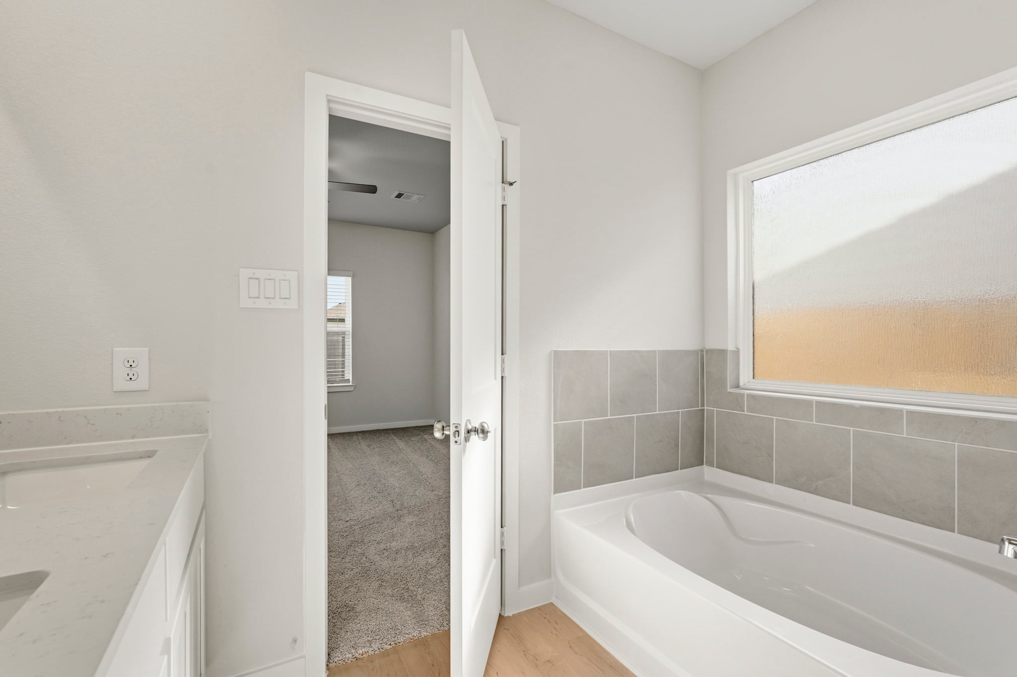 A bathroom with a bathtub and shower.