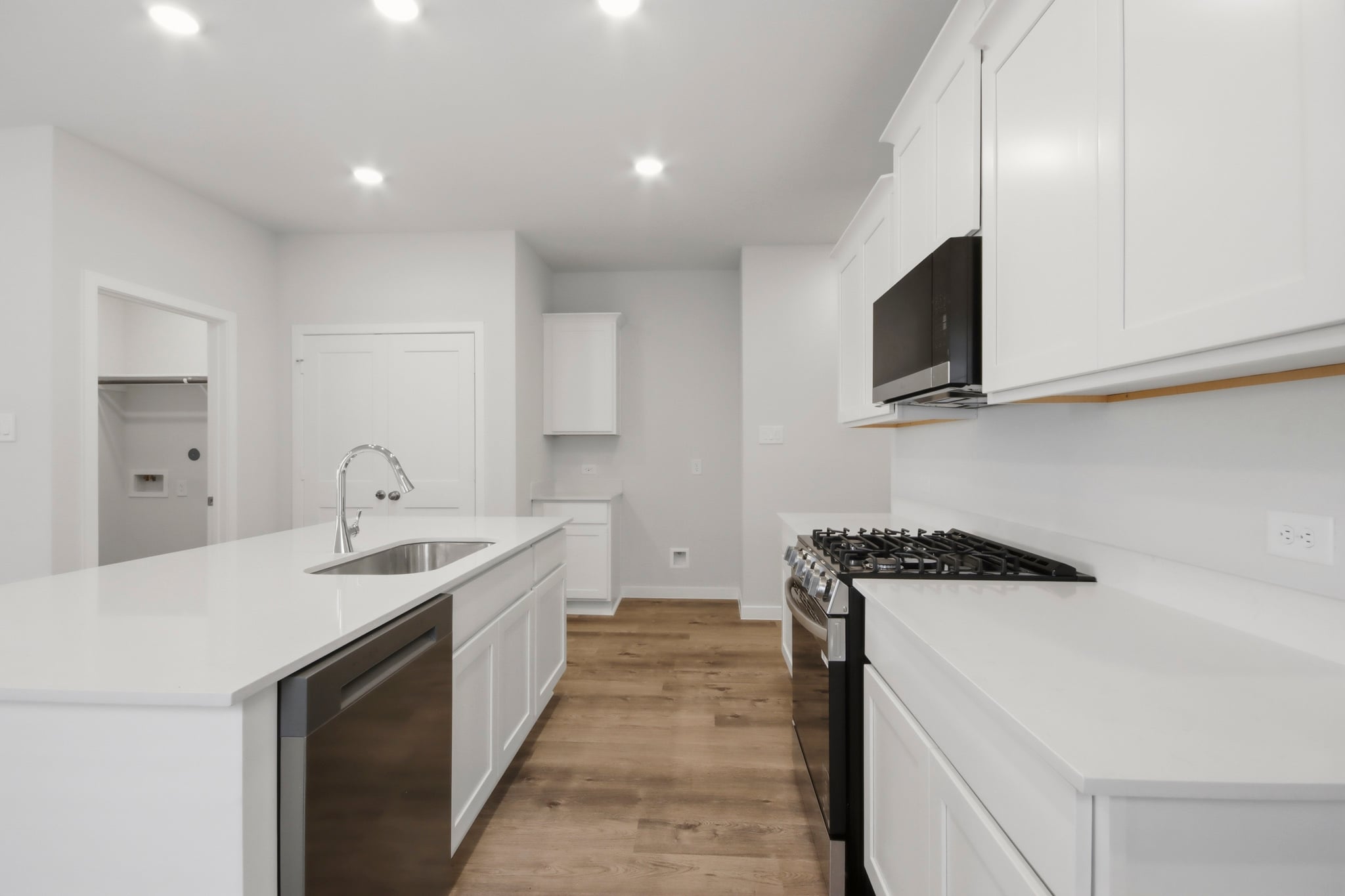 A kitchen with white cabinets.