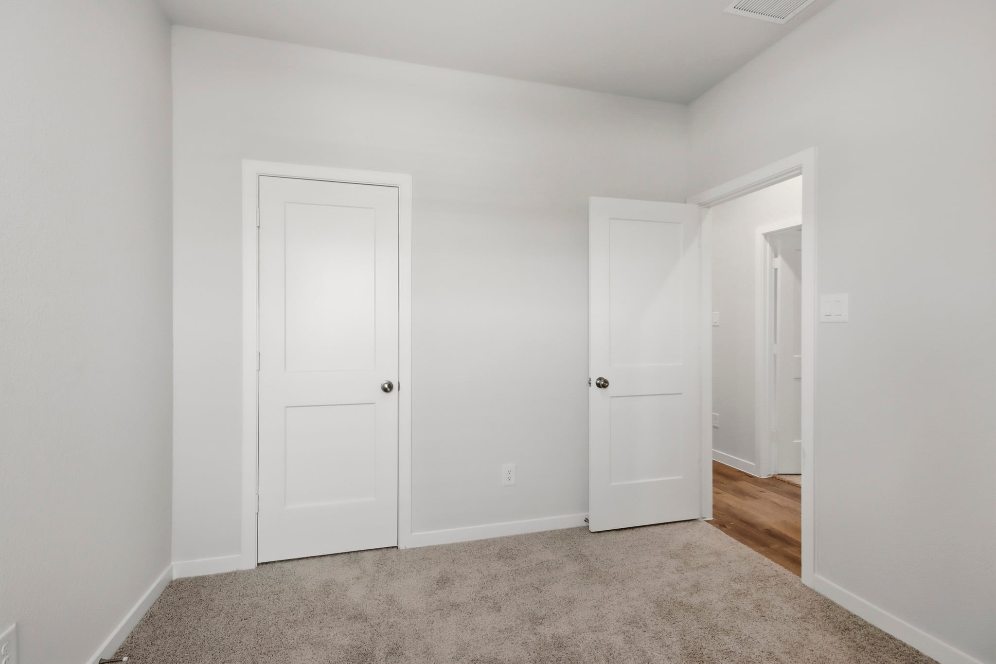 A hallway with white doors.
