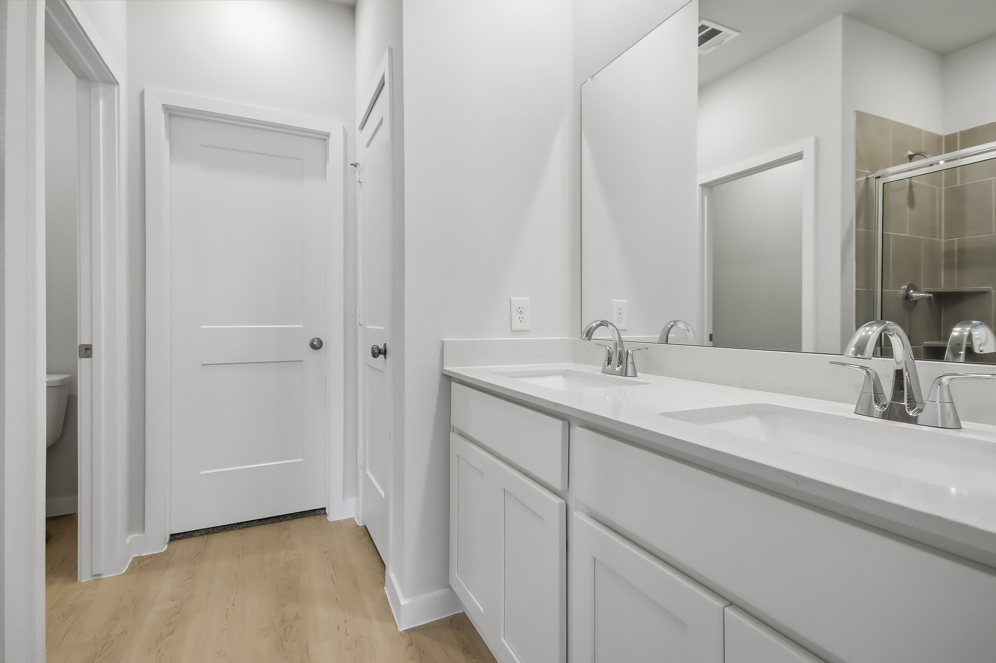 A bathroom with a large mirror.