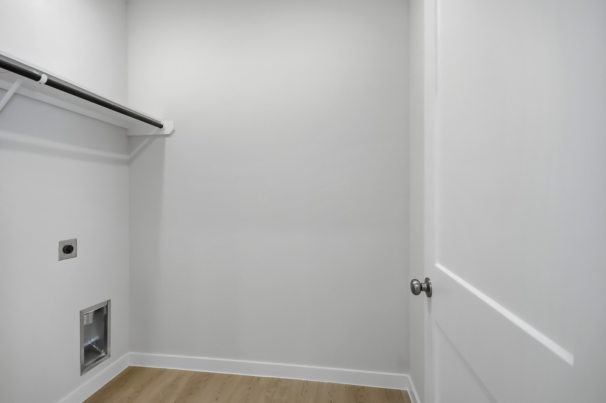 A white door with a metal bar.
