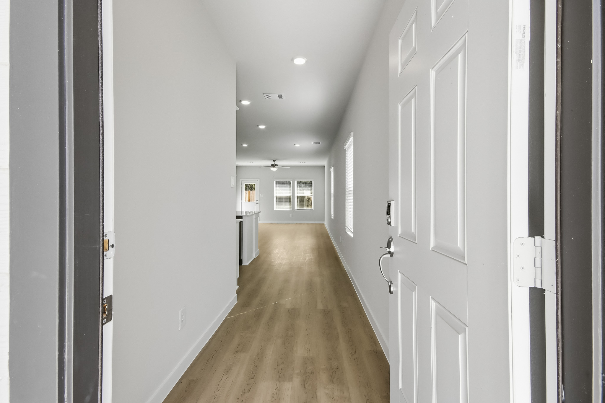 A hallway with white doors.