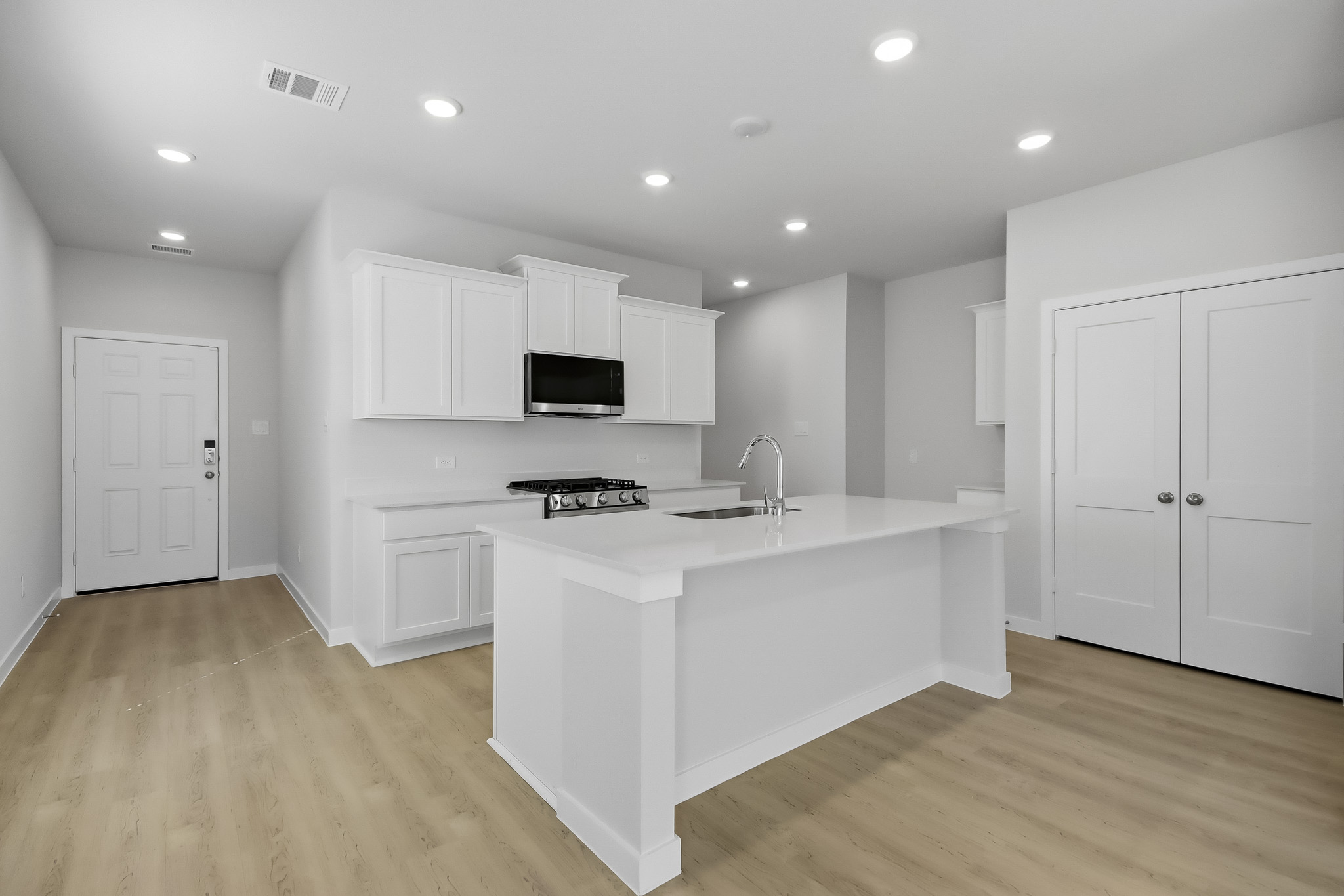 A kitchen with white cabinets.