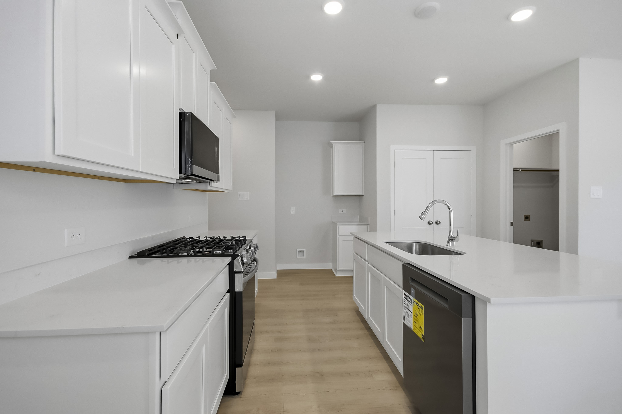 A kitchen with white cabinets.