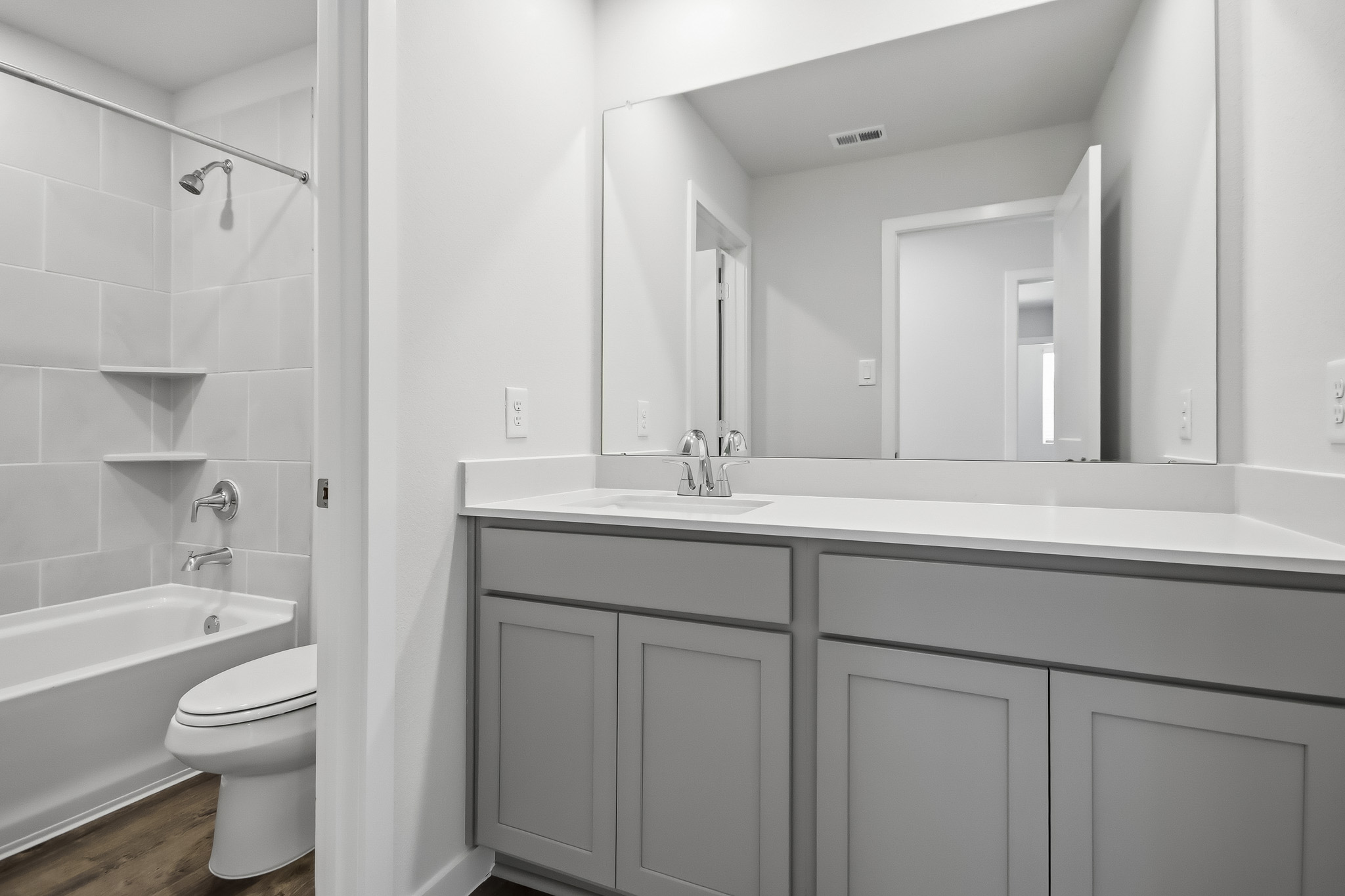 A bathroom with a tub sink and toilet.
