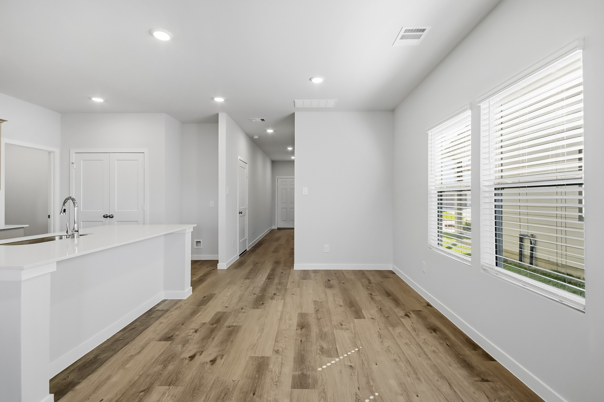 A large kitchen with white cabinets.