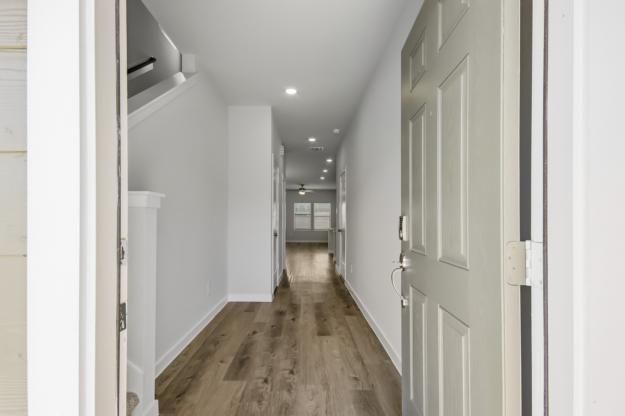 A hallway with white doors.