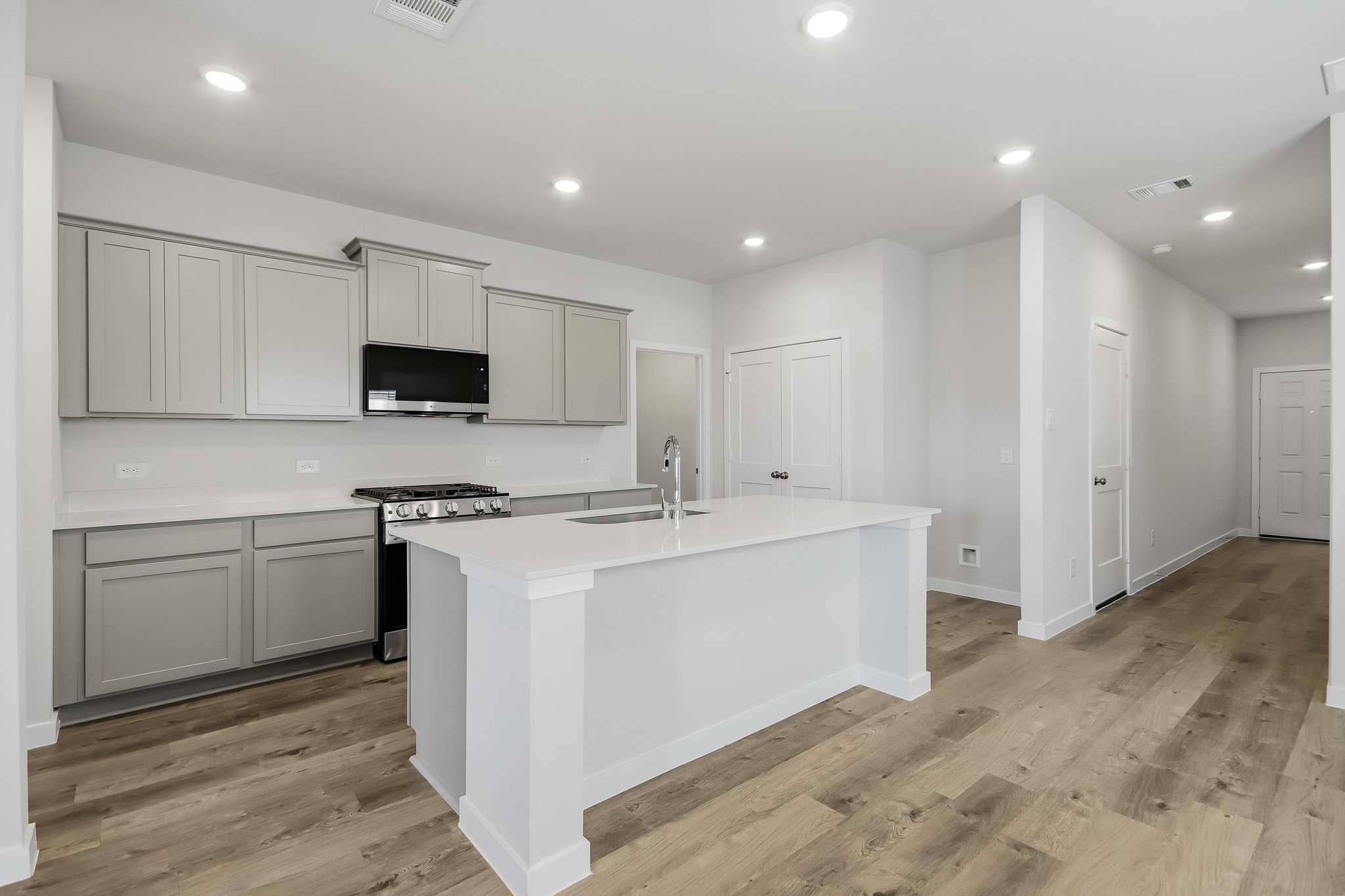 A kitchen with white cabinets.