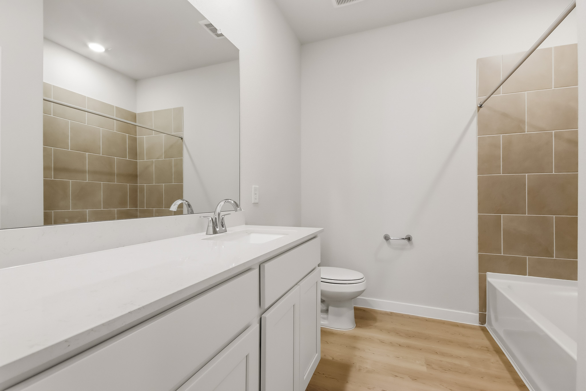 A bathroom with a tub toilet and sink.